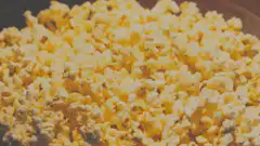 Hand grabbing popcorn
