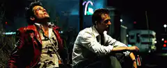 Two men drinking beer at night