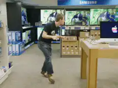 Man excitedly dances in electronics store