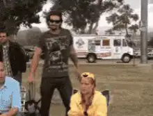 Man kicks chair and sits down