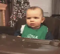 Baby in green bib points