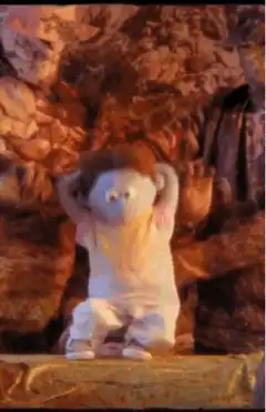 Blue puppet dancing on stage