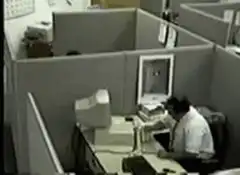 Man throws computer monitor in cubicle