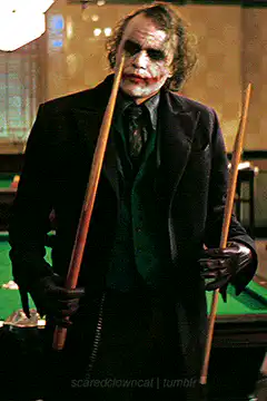 Joker holding pool cues