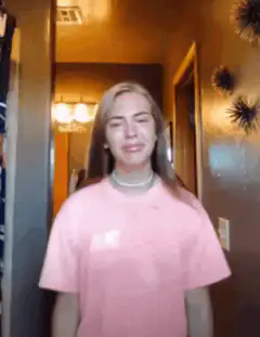 Girl in pink shirt dancing and making faces