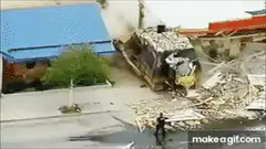 armored bulldozer demolishing building