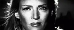 Uma Thurman winking and smiling