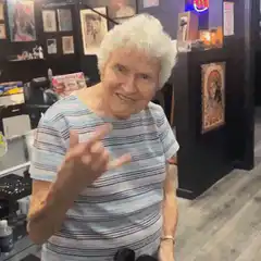 Old lady makes rock on hand gesture