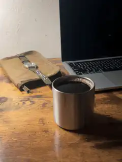 Coffee cup on desk with laptop