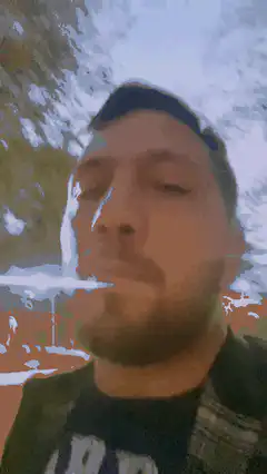 Man blowing smoke ring outdoors