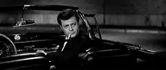 James Bond smoking in a car