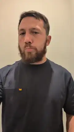 Man with beard looking at camera