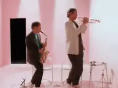 Two men playing saxophone and trumpet