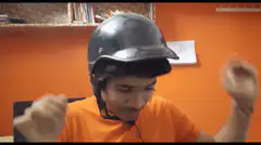 Guy in orange shirt and helmet dancing