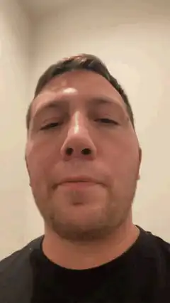 Man blinking and looking down