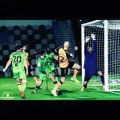 Soccer player scores and celebrates with team