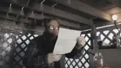 Man reading paper with wide eyes