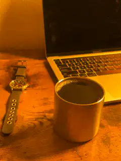 coffee cup and laptop on desk