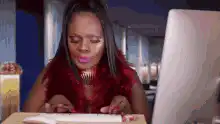 Woman typing on keyboard with pink lipstick