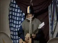 Kevin Smith playing guitar in football helmet