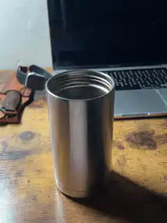 empty metal travel mug on desk