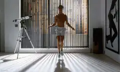 man jumps and shorts fall down