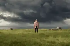Old man with beard in field