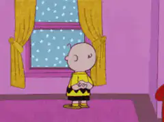 Charlie Brown standing by window