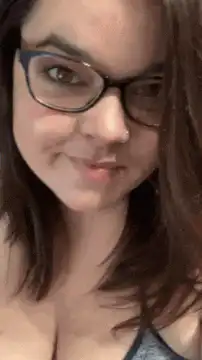 Woman winking and adjusting glasses