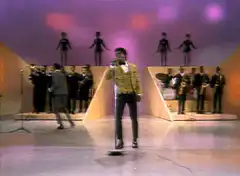 Elvis Presley falls off stool on stage
