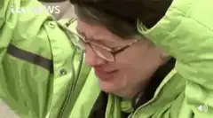 Man in green jacket crying then screaming