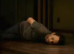 Man lying on floor with cigarette