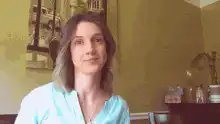 woman poses with hands on cheeks