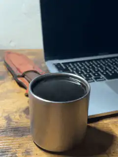 steaming metal cup on desk
