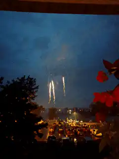 Fireworks exploding over a city at night