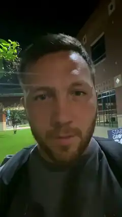 Man selfie at night outside building