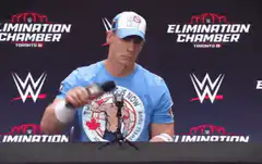 John Cena slams microphone on table