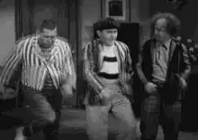 Three men dancing in striped shirts