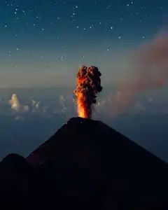 volcano erupting at night
