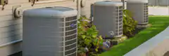Three outdoor AC units next to house