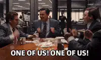 Three men in suits clapping One of Us
