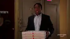 Pierce holds pizza boxes while apartment explodes