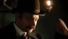 Sherlock Holmes removes his hat