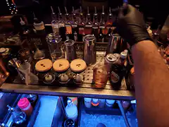 Bartender mixing drinks behind the bar