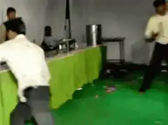 Two men dancing on green floor