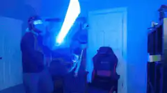 Man swinging a glowing lightsaber