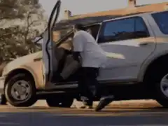 man pulls giant sack from car