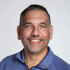 Man in blue polo smiling