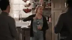 Woman pulls beer bottle from plastic bag