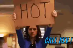 Emilia Clarke holds up HOT sign